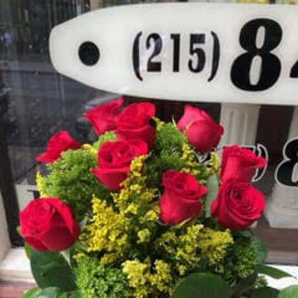 Bouquet of red roses with yellow filler flowers