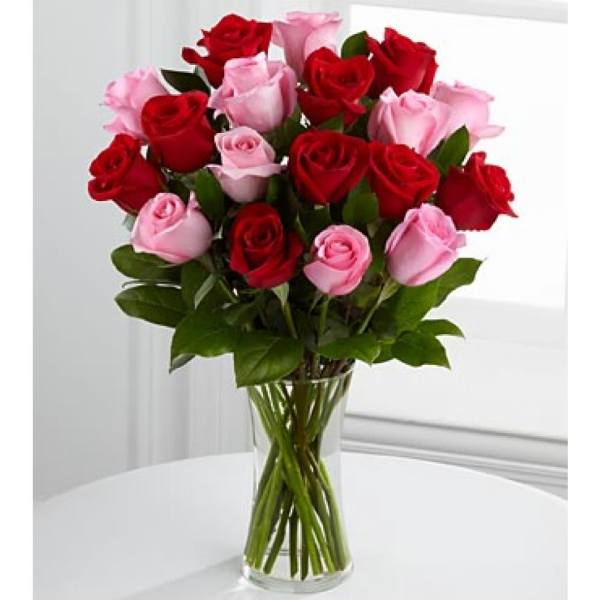 Bouquet of red and pink roses in a clear glass vase