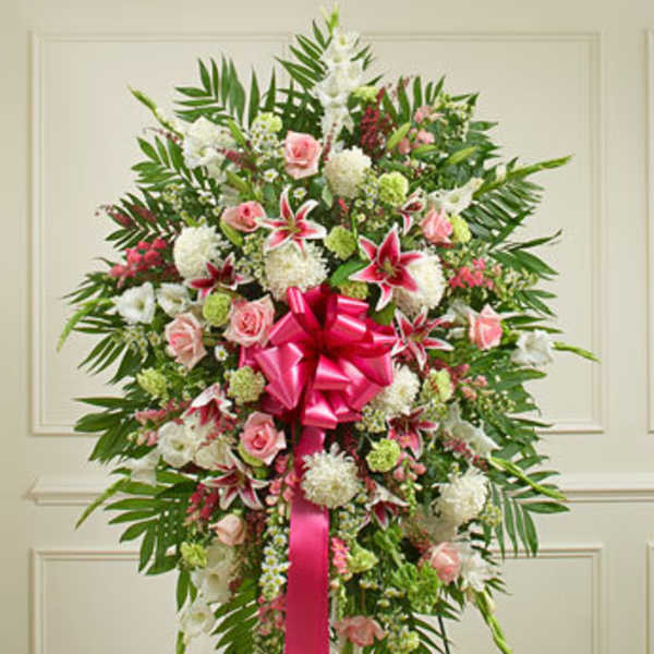 Standing floral spray with pink and white flowers and a bright pink ribbon