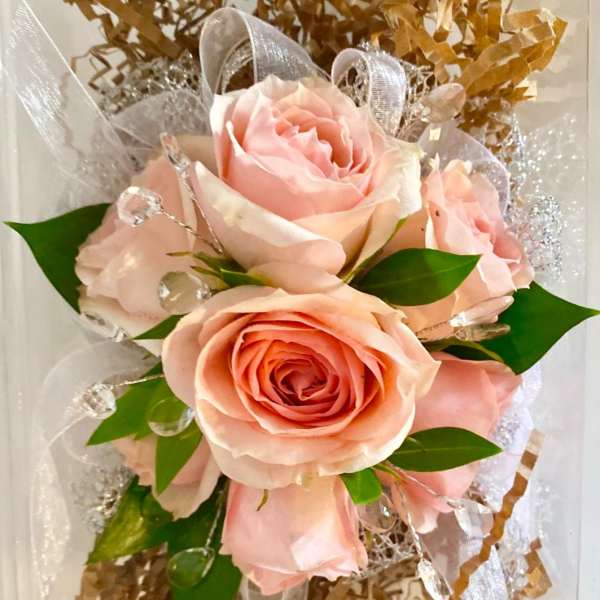 Bouquet of pale pink roses with clear decorative accents and ribbon