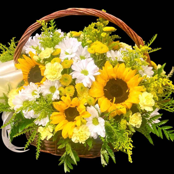 Basket of yellow sunflowers and white daisies with a white bow