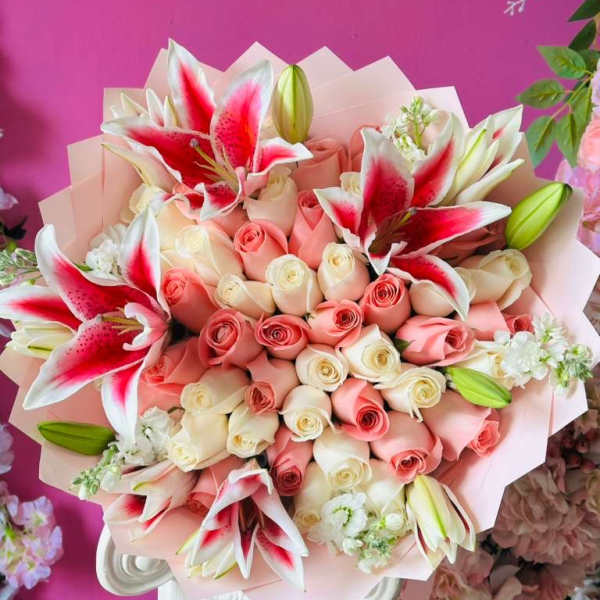 Bouquet of pink and white roses with red-and-white lilies