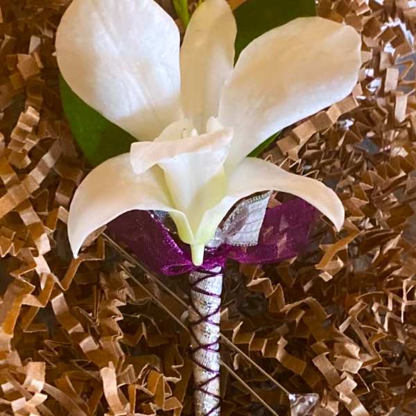 White calla lily boutonniere with purple ribbon wrap