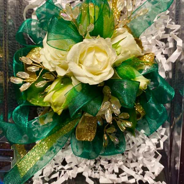 White rose bouquet with green and gold ribbon accents