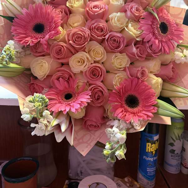 Pink and cream rose bouquet with hot pink gerbera daisies and lilies