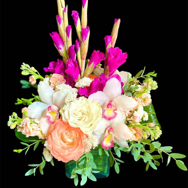 Mixed bouquet with pink and white flowers in a green vase