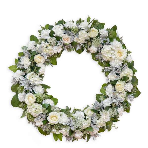 Round floral wreath with white roses and mixed white blooms