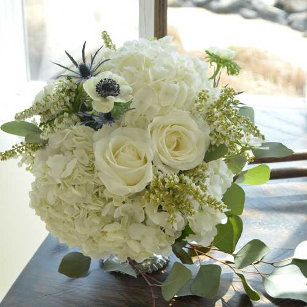 White rose and hydrangea bouquet with green foliage