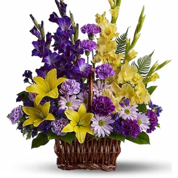Purple and yellow floral basket arrangement with daisies and lilies
