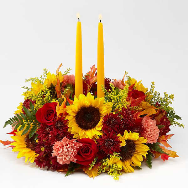Autumn floral centerpiece with two yellow taper candles