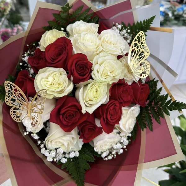 Bouquet of red and white roses with butterfly decorations