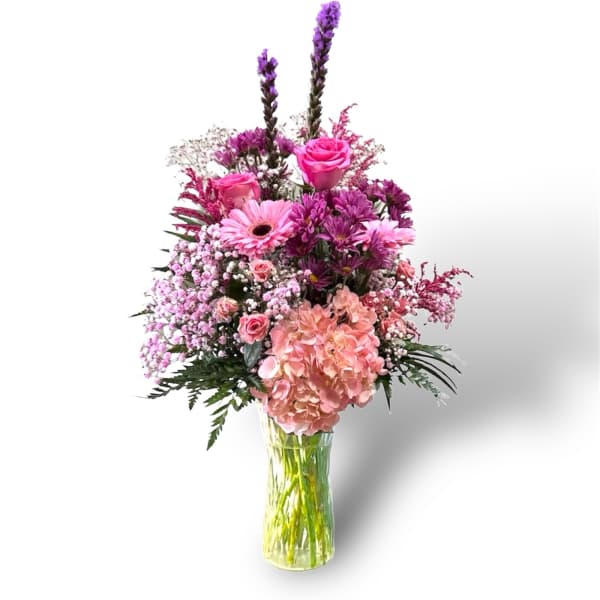 Pink and purple mixed bouquet in a clear glass vase