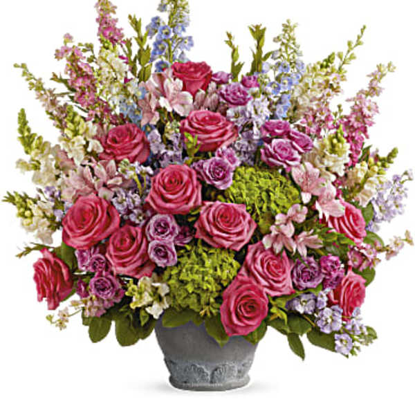 Pink roses and mixed pastel flowers in a gray vase