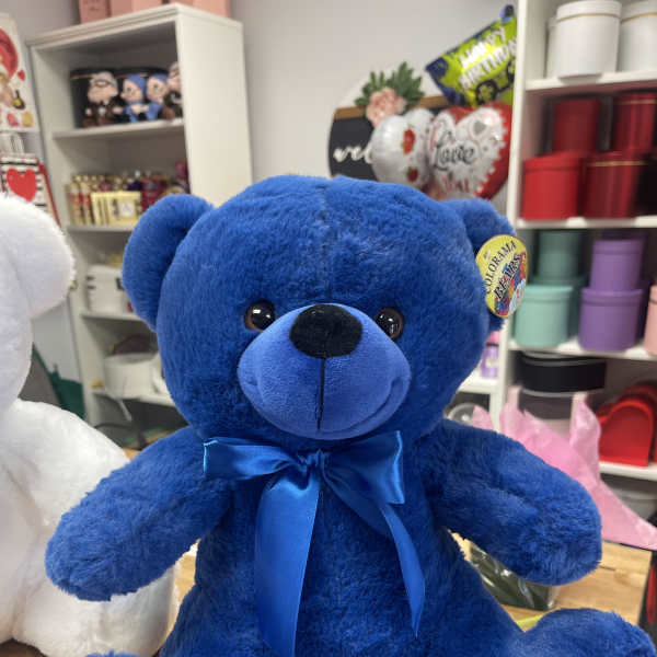 Blue teddy bear with a satin ribbon bow