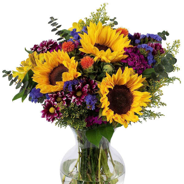 Bouquet of sunflowers and mixed colorful flowers arranged in a clear glass vase