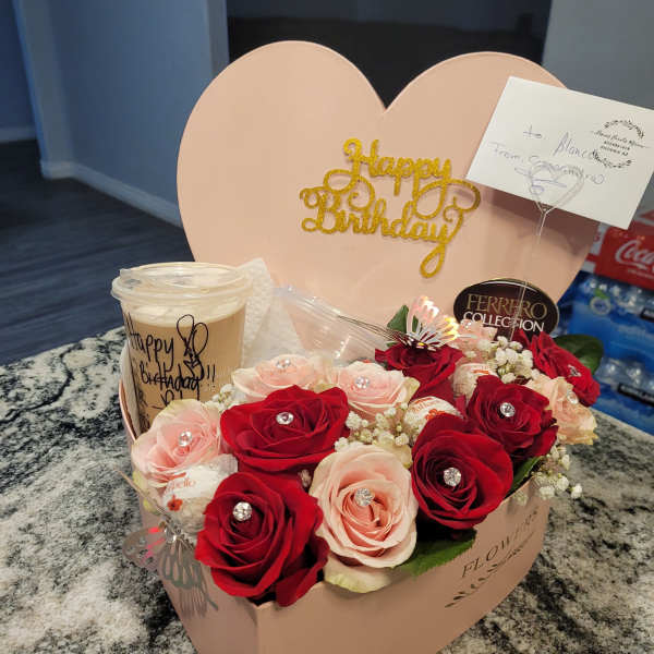 Heart-shaped birthday gift box with red and blush roses and chocolates