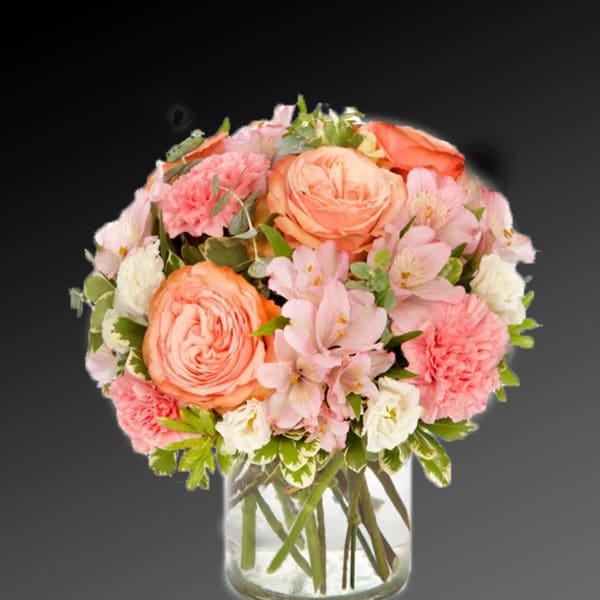Pink and peach bouquet in a clear glass vase