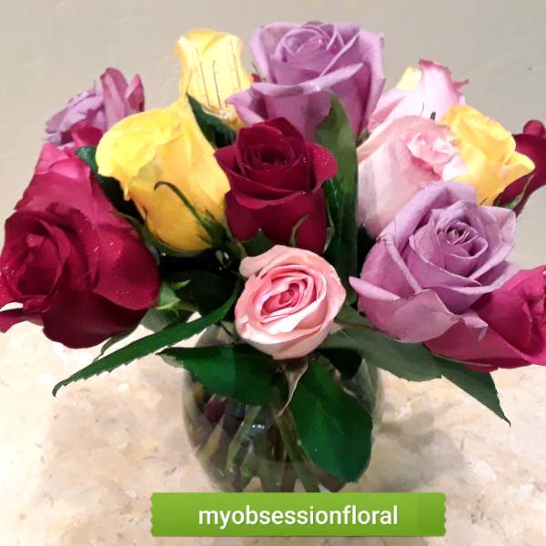 Bouquet of multicolored roses in a glass vase
