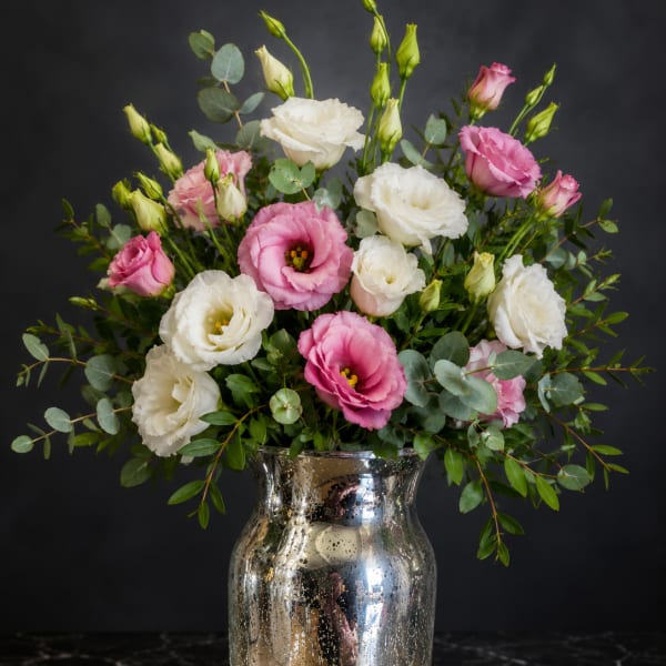 Pink and white lisianthus bouquet in a silver vase