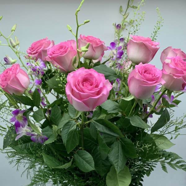 Pink roses with purple accents in a mixed bouquet
