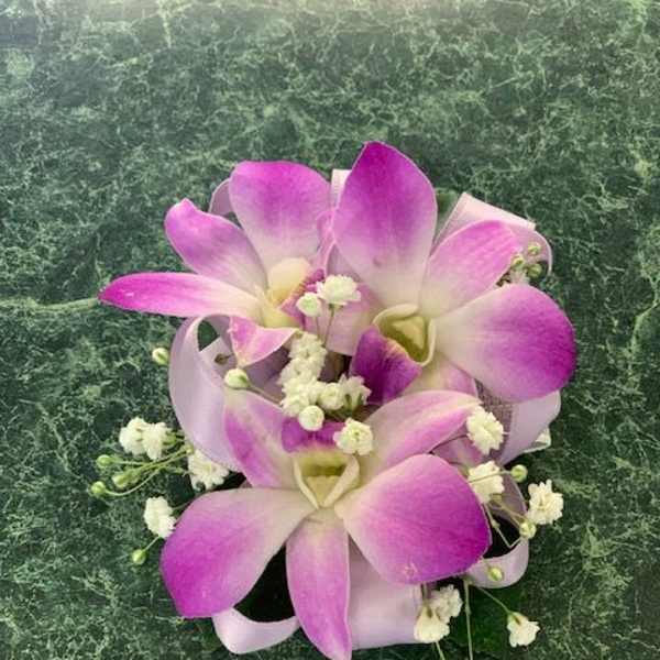 Pink and white orchid bouquet with small white filler flowers