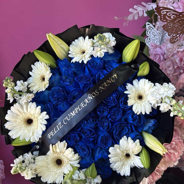 Blue rose bouquet with white daisies and lily buds in black wrap