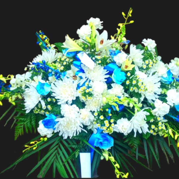 Large white and blue floral spray with lilies and daisies