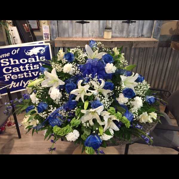Large blue and white floral spray with lilies and roses