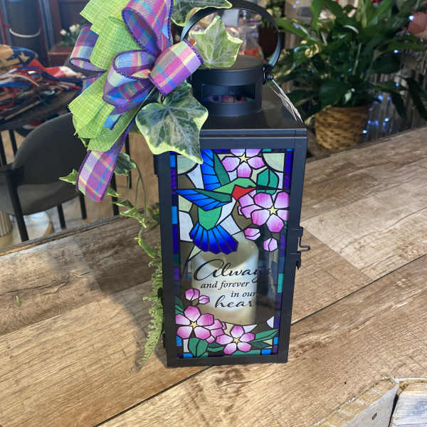 Decorative memorial lantern with a hummingbird panel and ribbon bow