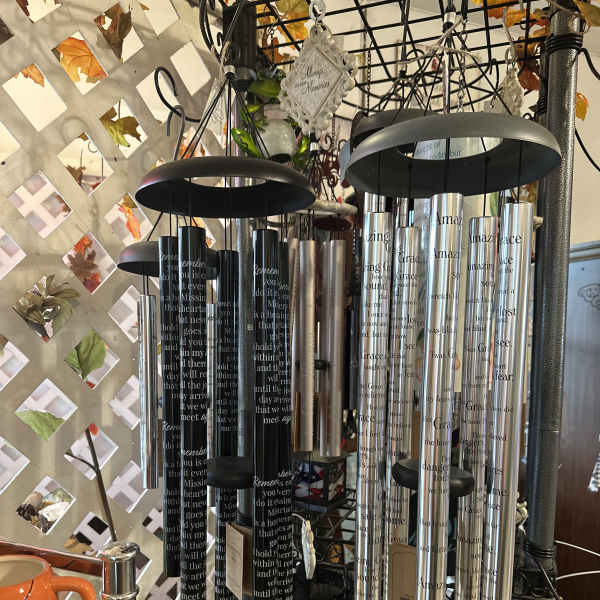 Hanging memorial wind chimes with engraved tubes and black tops