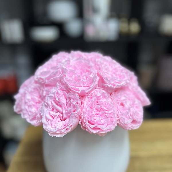 Pink peonies arranged in a white vase