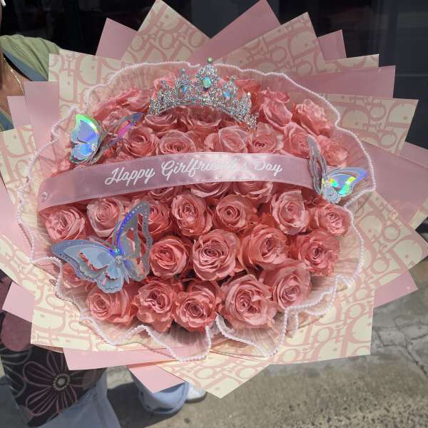 Pink rose bouquet with a tiara and butterfly decorations