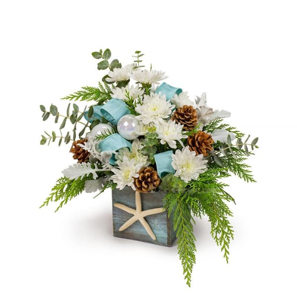 White flowers in a square vase with pinecones and blue ribbon