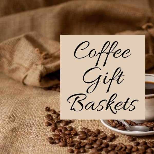 Coffee cup and saucer with coffee beans and a sign reading Coffee Gift Baskets