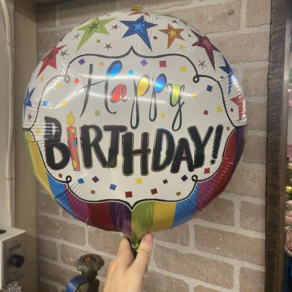 Round birthday balloon with colorful stars and confetti design