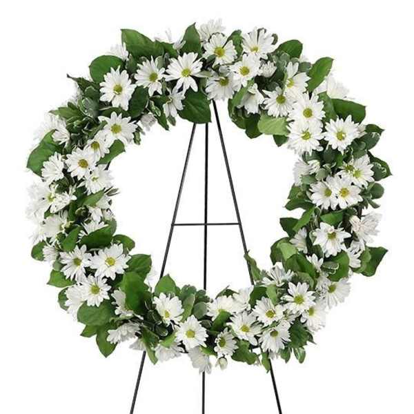 White daisy wreath on a black stand