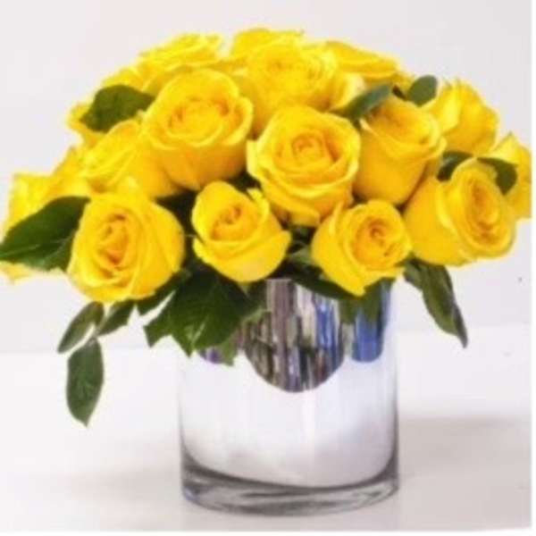 Yellow roses arranged in a clear glass vase