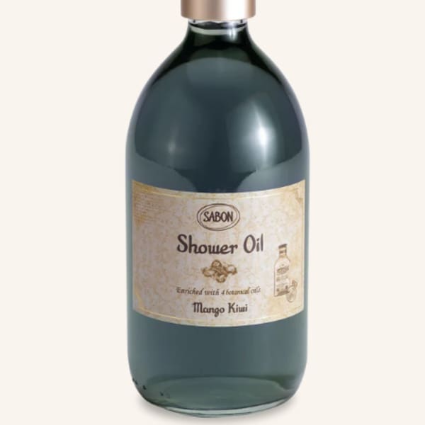 Bottle of shower oil with a gold cap and label