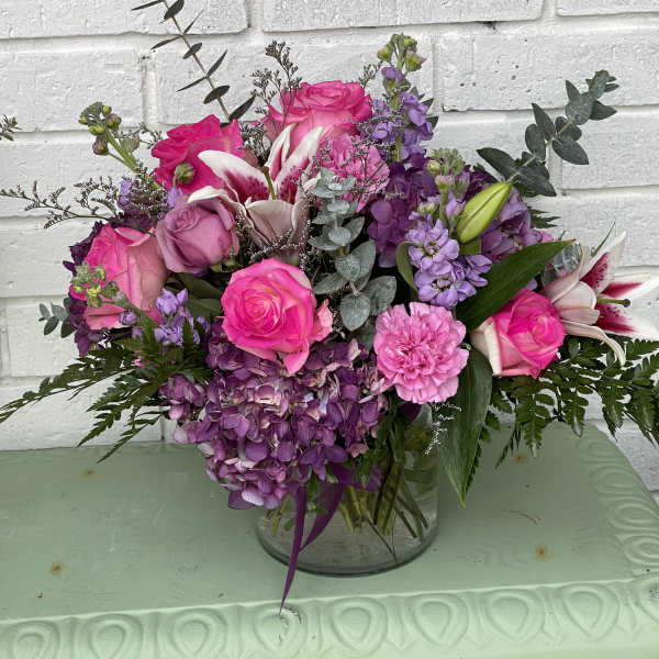 Pink and purple bouquet in a clear glass vase