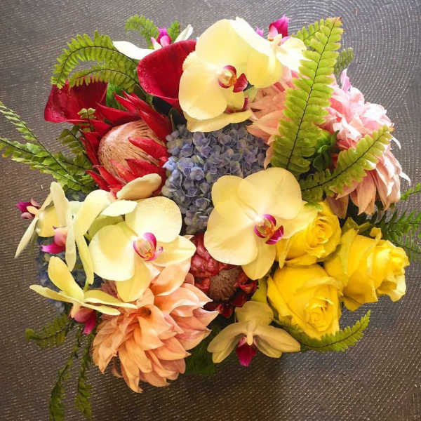 Mixed bouquet with orchids, roses, hydrangea, and tropical blooms