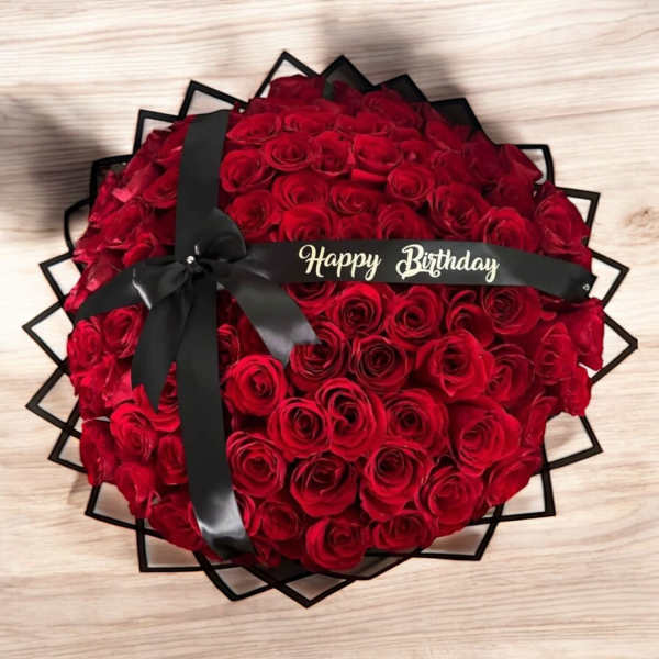 Round bouquet of red roses with a black ribbon and Happy Birthday band