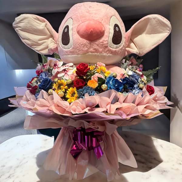 Large pink plush character above a colorful bouquet of flowers