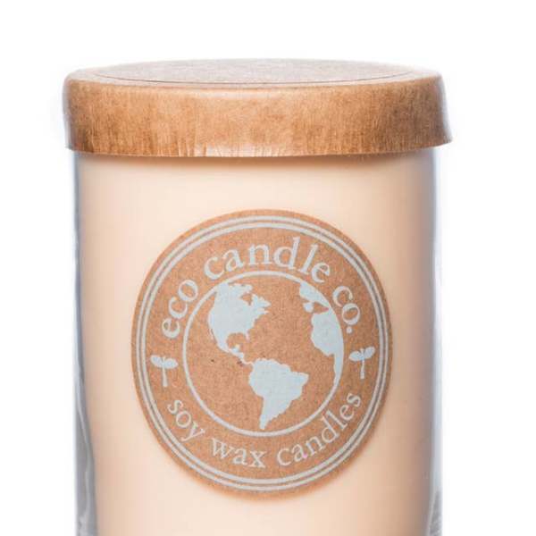 Soy wax candle in a clear glass jar with a wooden lid