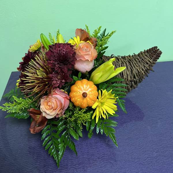Bouquet with roses, chrysanthemums, and a small pumpkin accent