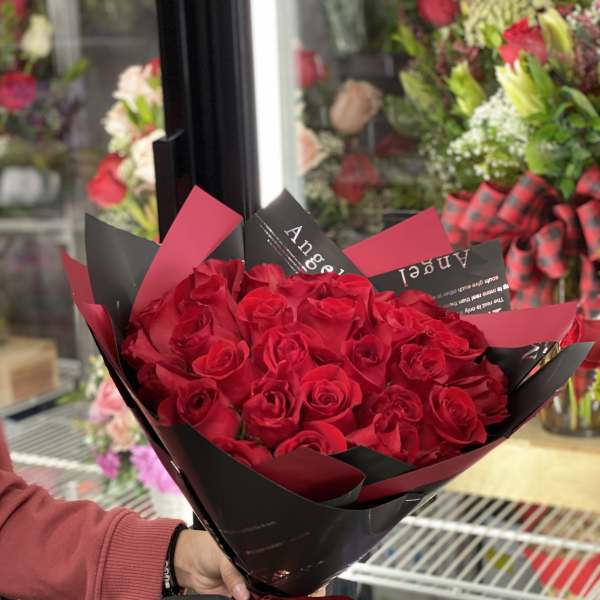 Bouquet of red roses wrapped in black and red paper