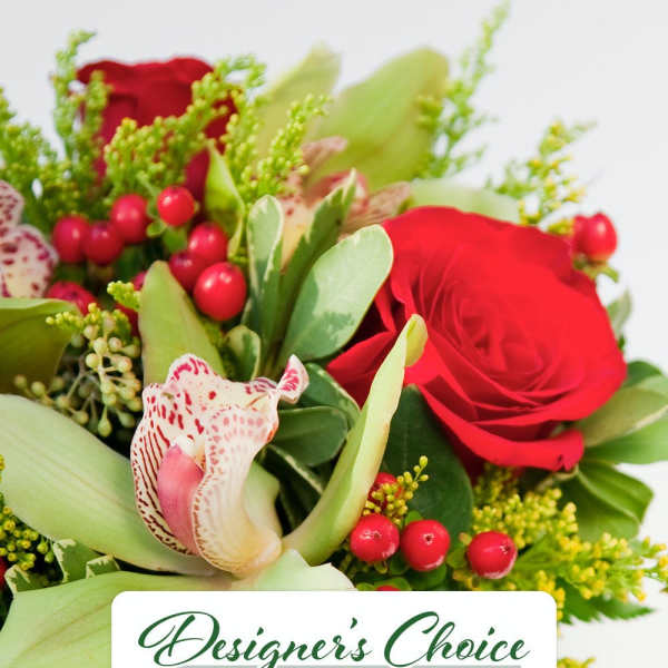 Mixed bouquet with red roses, spotted orchid, and green accents