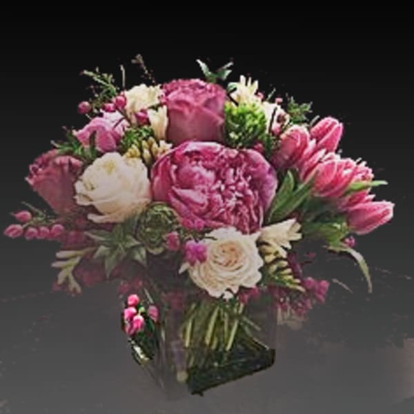 Pink and white bouquet in a clear glass vase