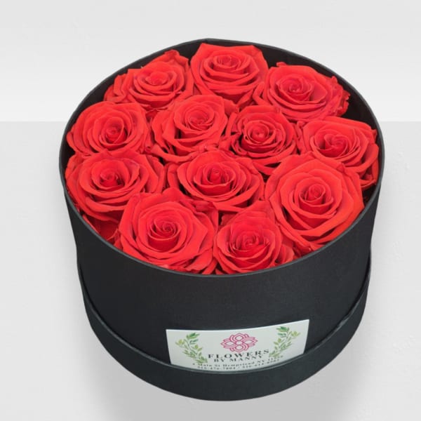 Red roses arranged in a round black box