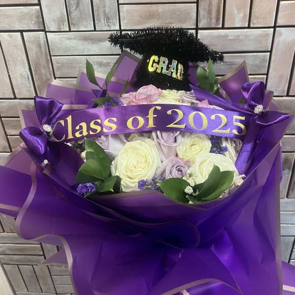 Purple bouquet with roses and a graduation topper