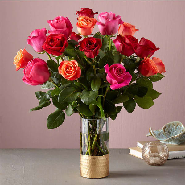 Bouquet of multicolored roses in a clear glass vase